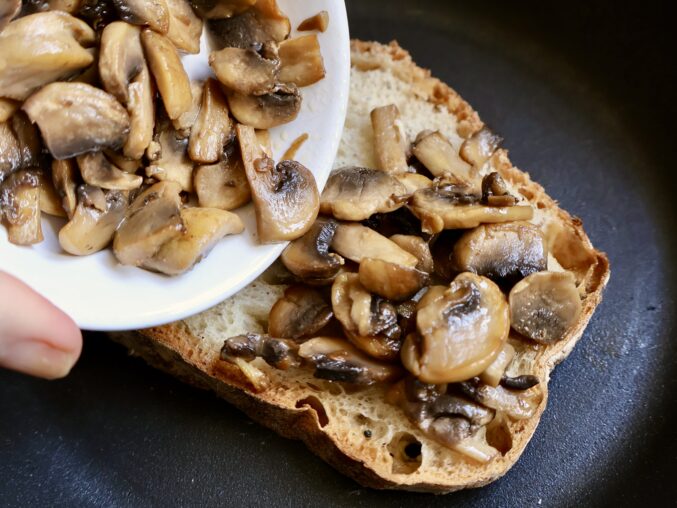 adding mushrooms to bread