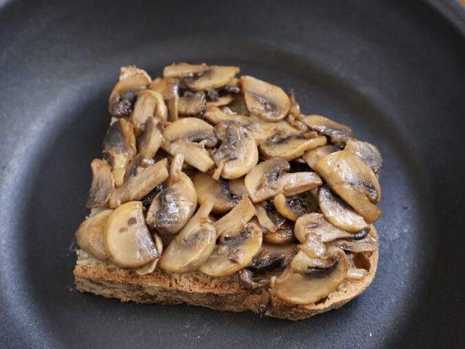 making a grilled cheese and mushroom sandwich