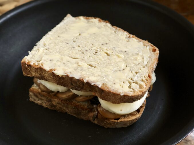 cooking the grilled cheese and mushroom sandwich