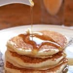 pouring syrup on buttermilk pancakes