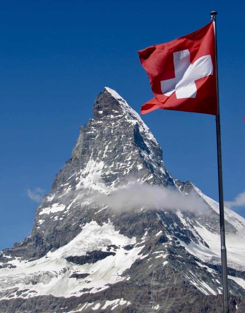 Swiss flag in front of the Matterhorn