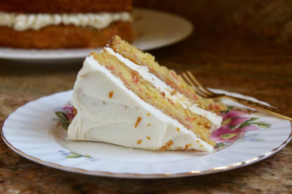 slice of pumpkin cake with Best orange cream cheese frosting