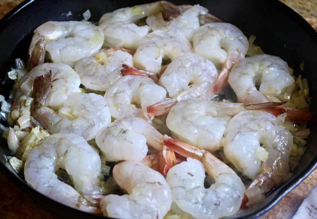 seafood and garlic in a cast iron pan