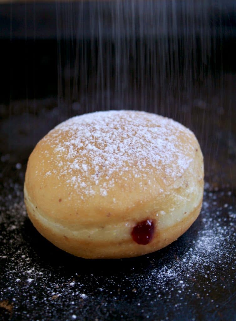 yeast doughnut getting dusted