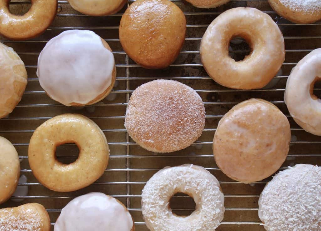 Rack of different perfect vegan doughnuts