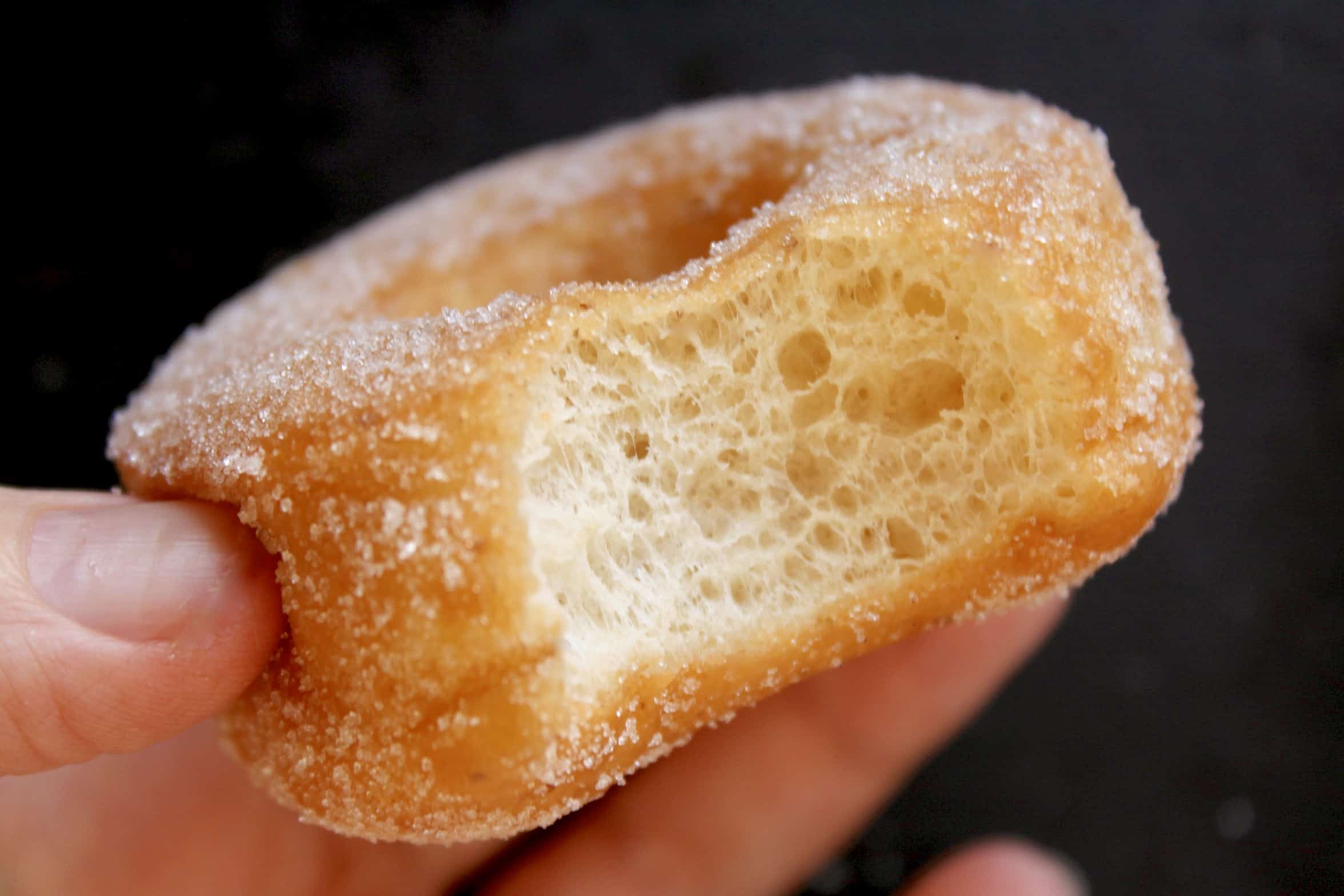 close up of a bitten vegan handheld doughnut