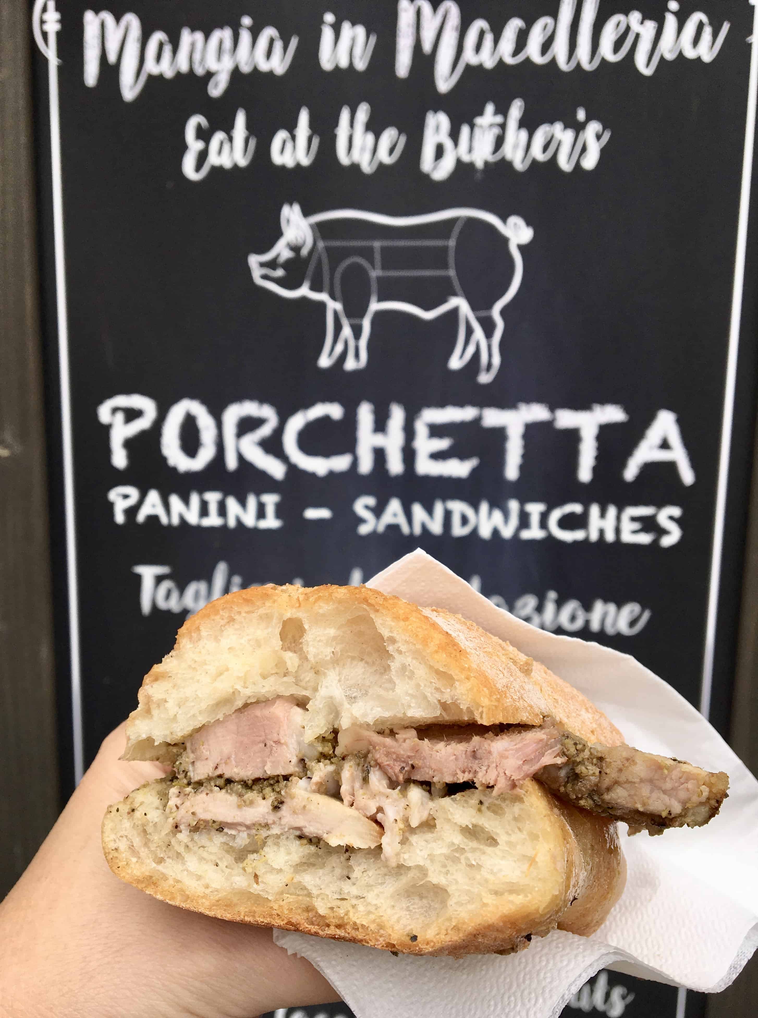 Porchetta panini in Orvieto in front of a butcher sign