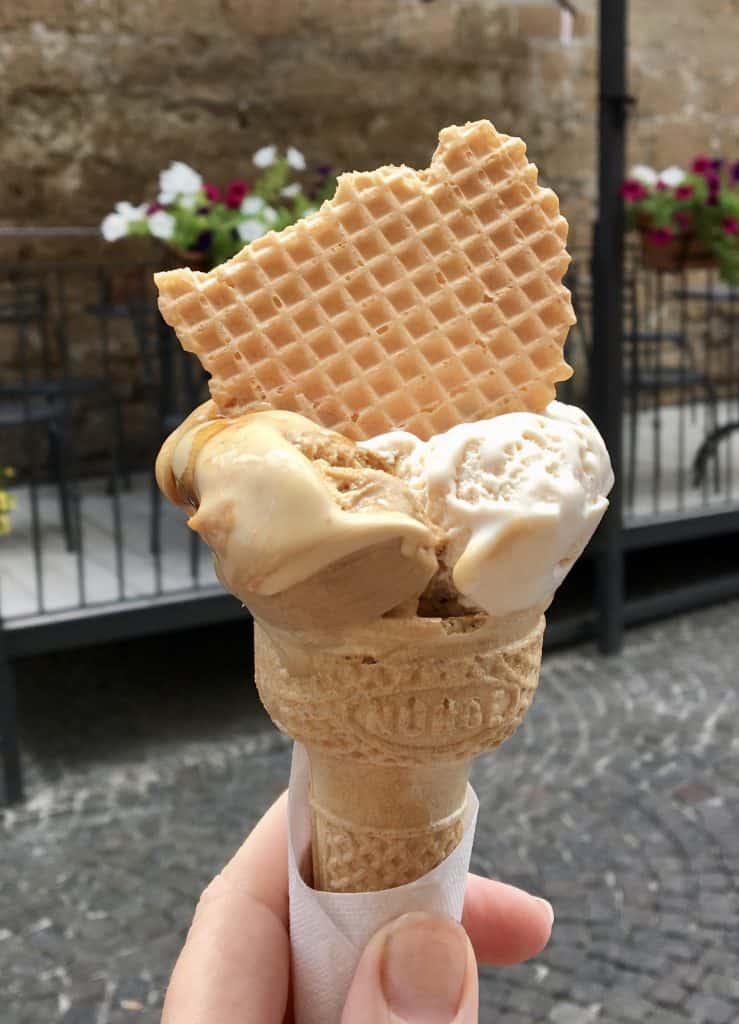 handheld gelato in a cone with a wafer on top in Orvieto