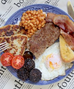 full Scottish breakfast with lorne sausage, black pudding, egg, toast, bacon, tomato, potato scones and Heinz beans