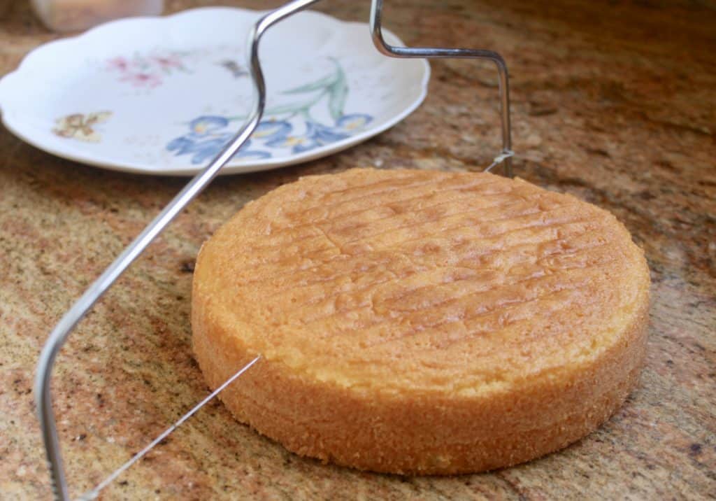 slicing the top off of a Victoria sandwich