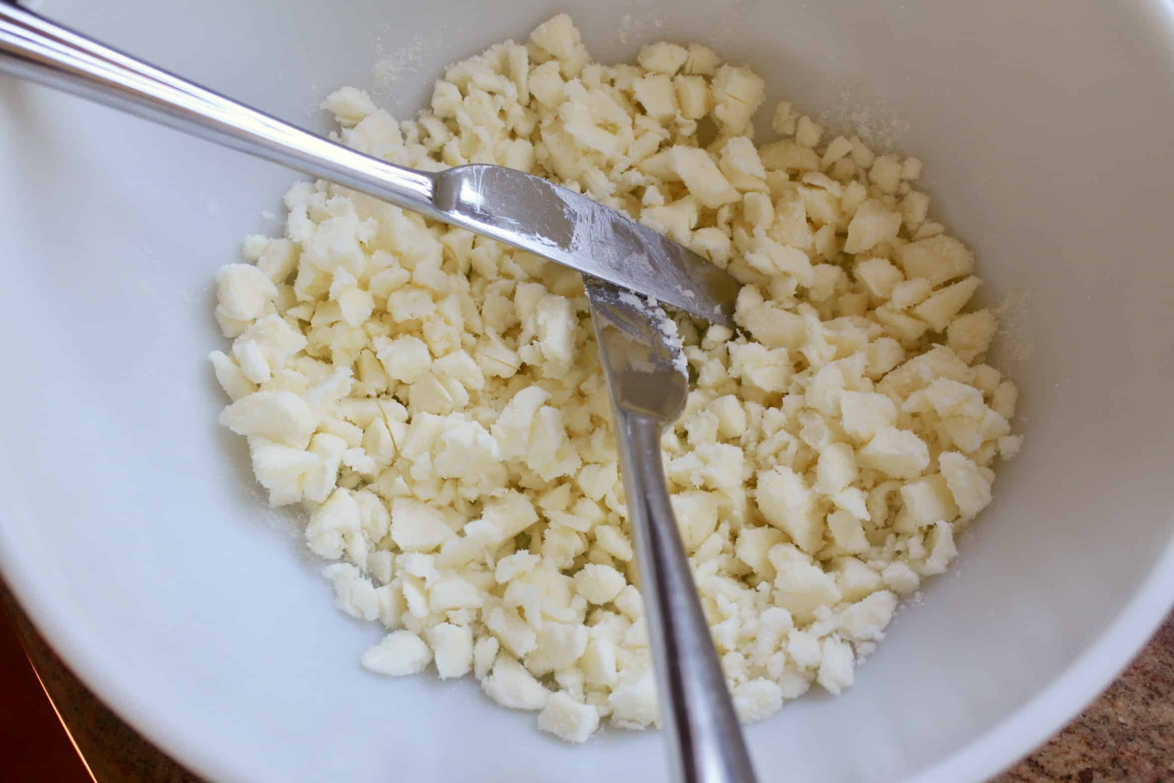 cutting butter and sugar in a bowl