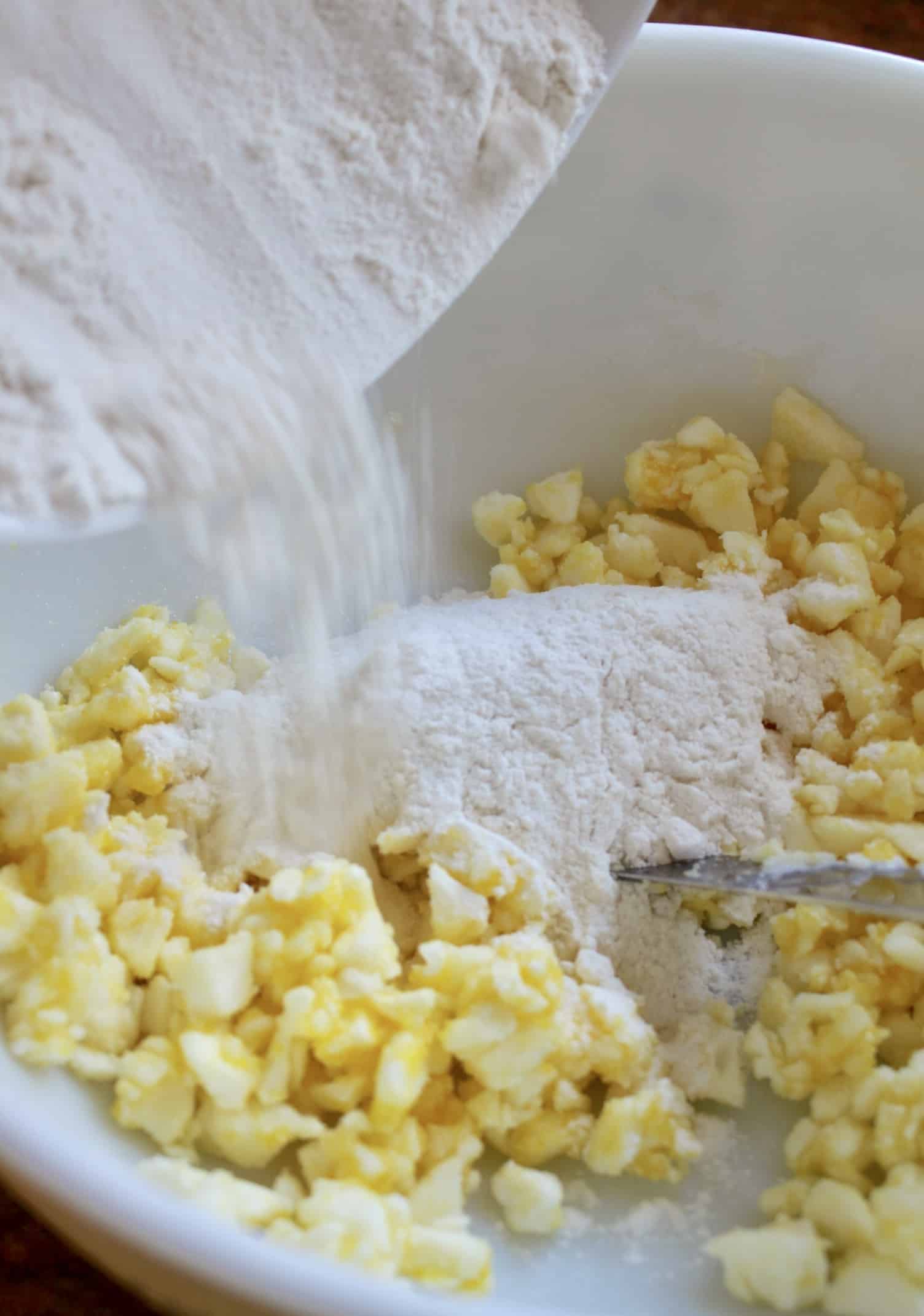 adding flour to eggs, sugar and butter for Snow Cake