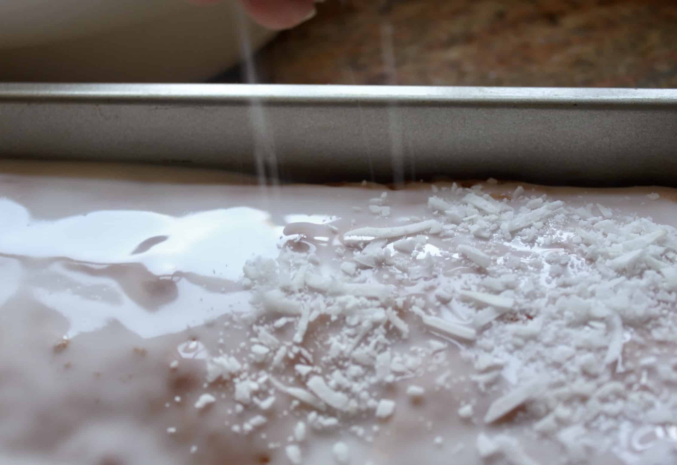 adding coconut to the snow cake