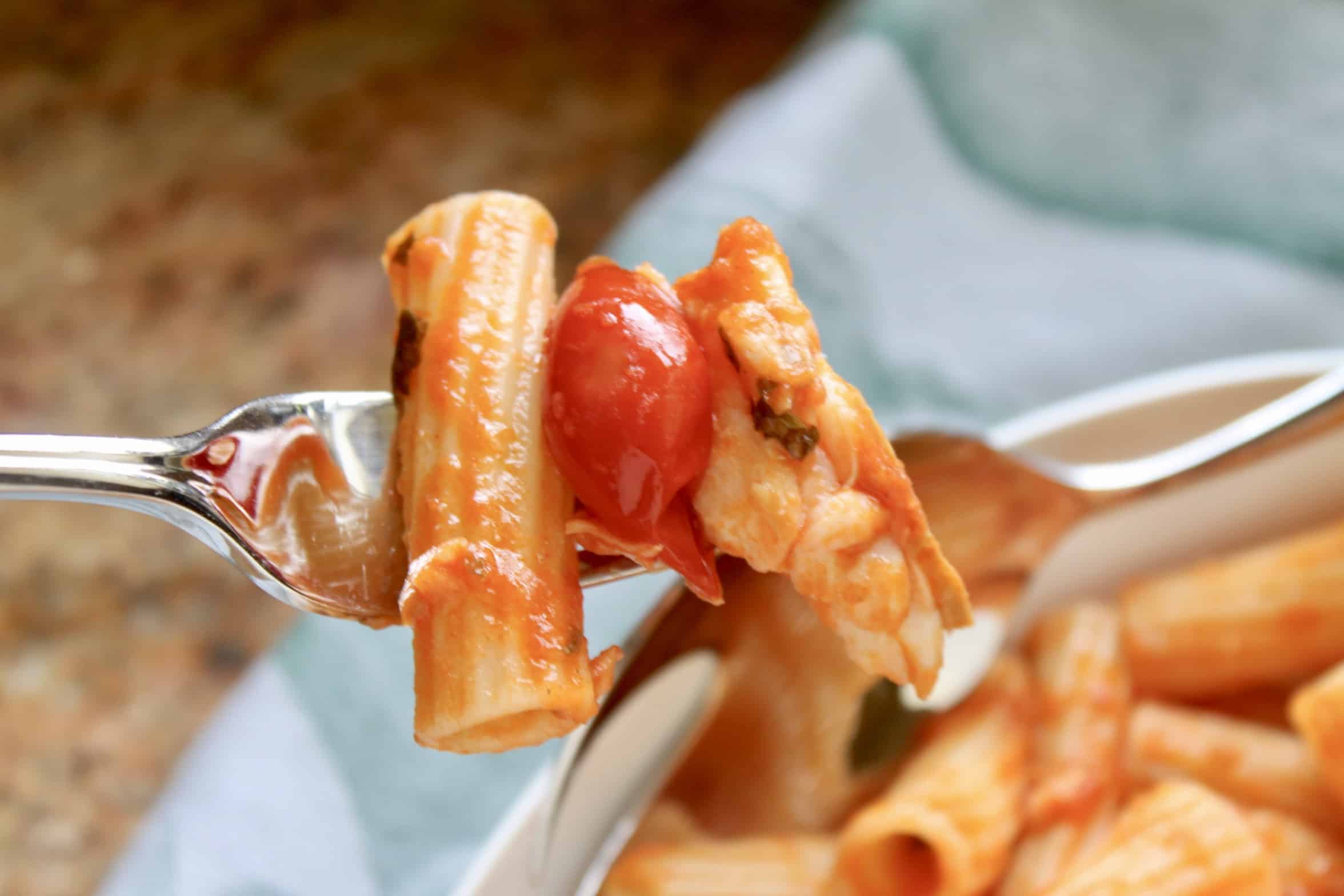 fish pasta with pomodorino on a fork