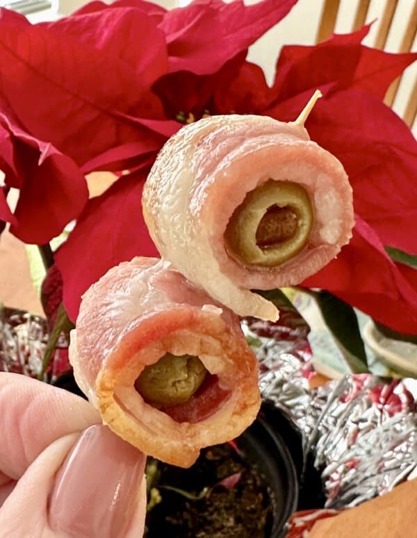 bacon wrapped olives on a toothpick