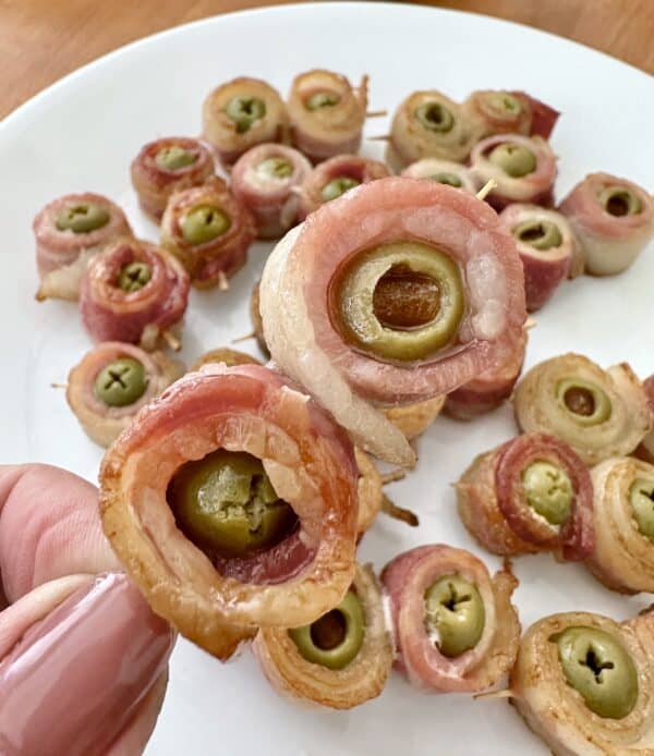 bacon wrapped olives on a toothpick