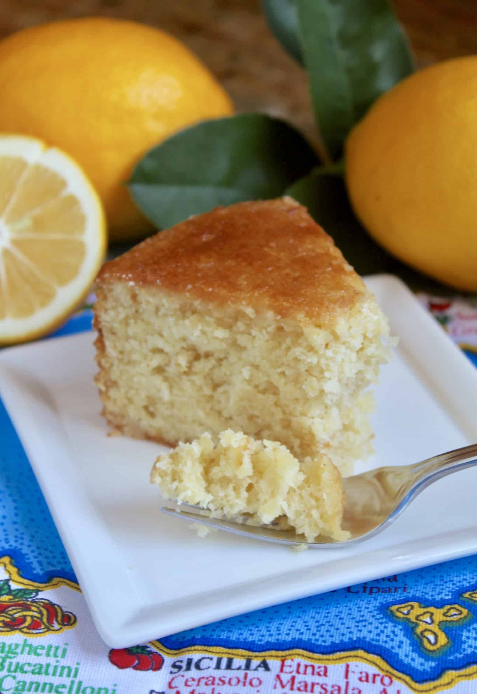 Sicilian whole lemon cake on a plate with a fork