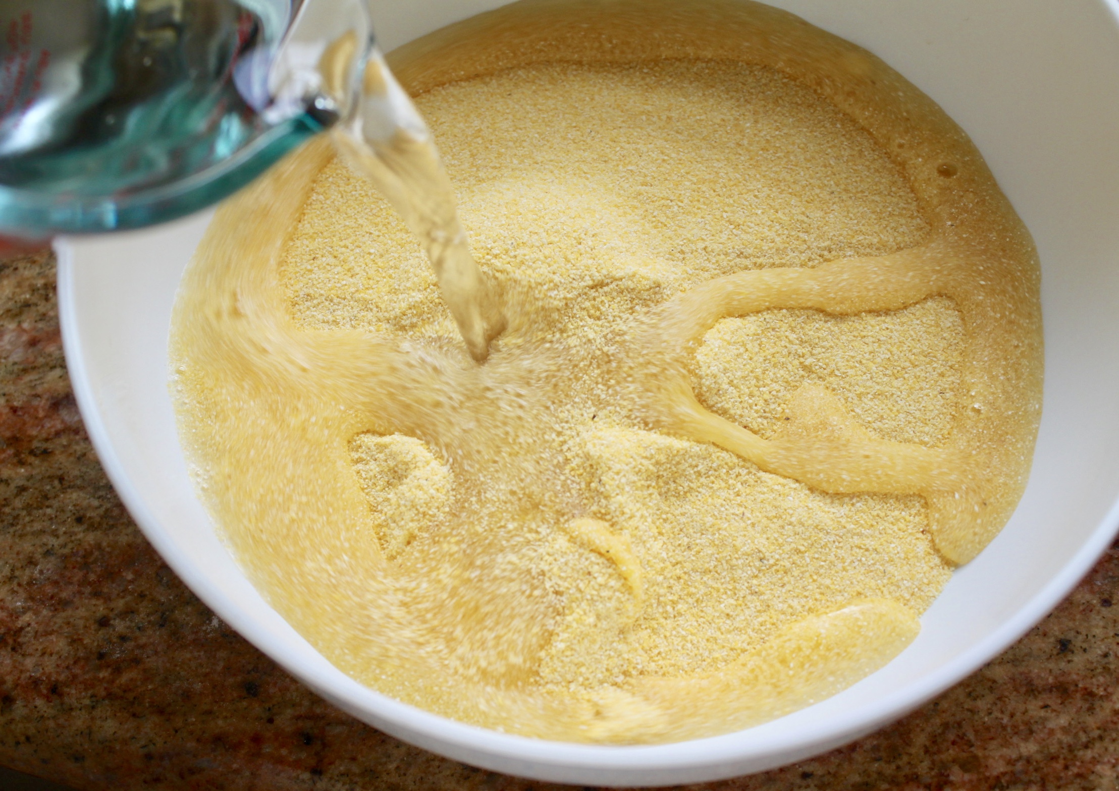adding cold water to polenta