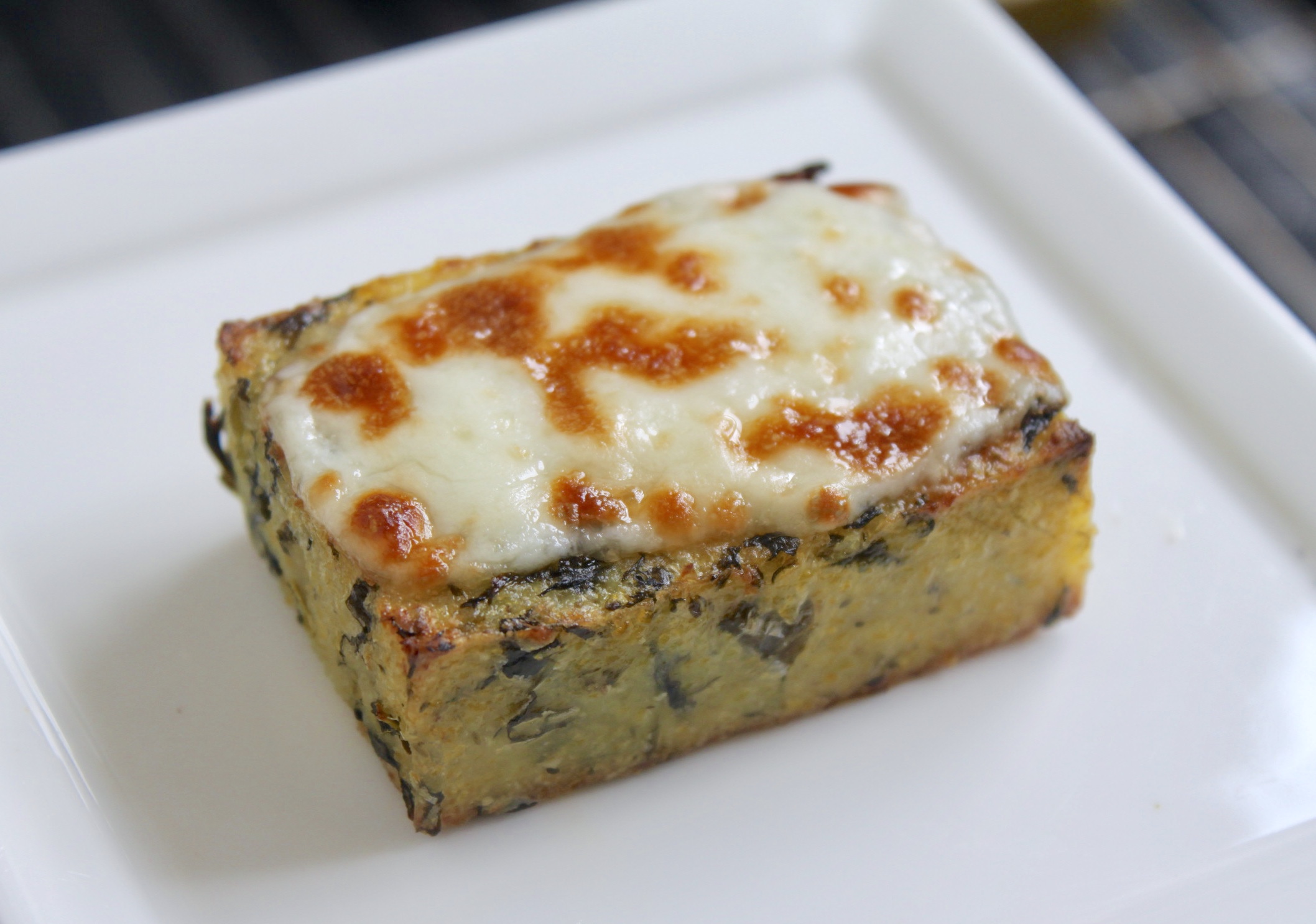 Piece of grilled polenta with cheese