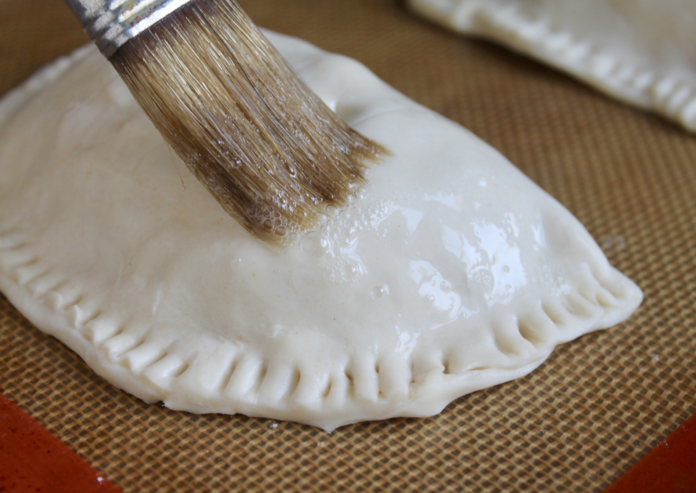 brushing puff pastry with egg white