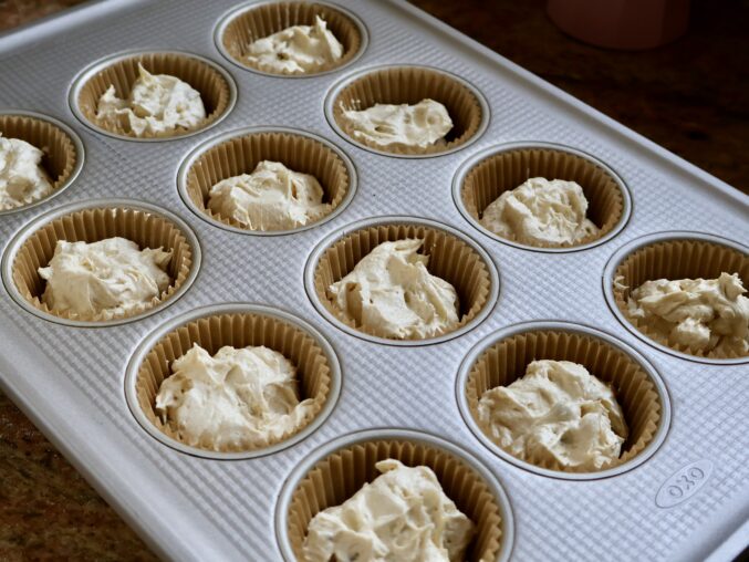 cupcake tray with coffee and walnut cake batter 