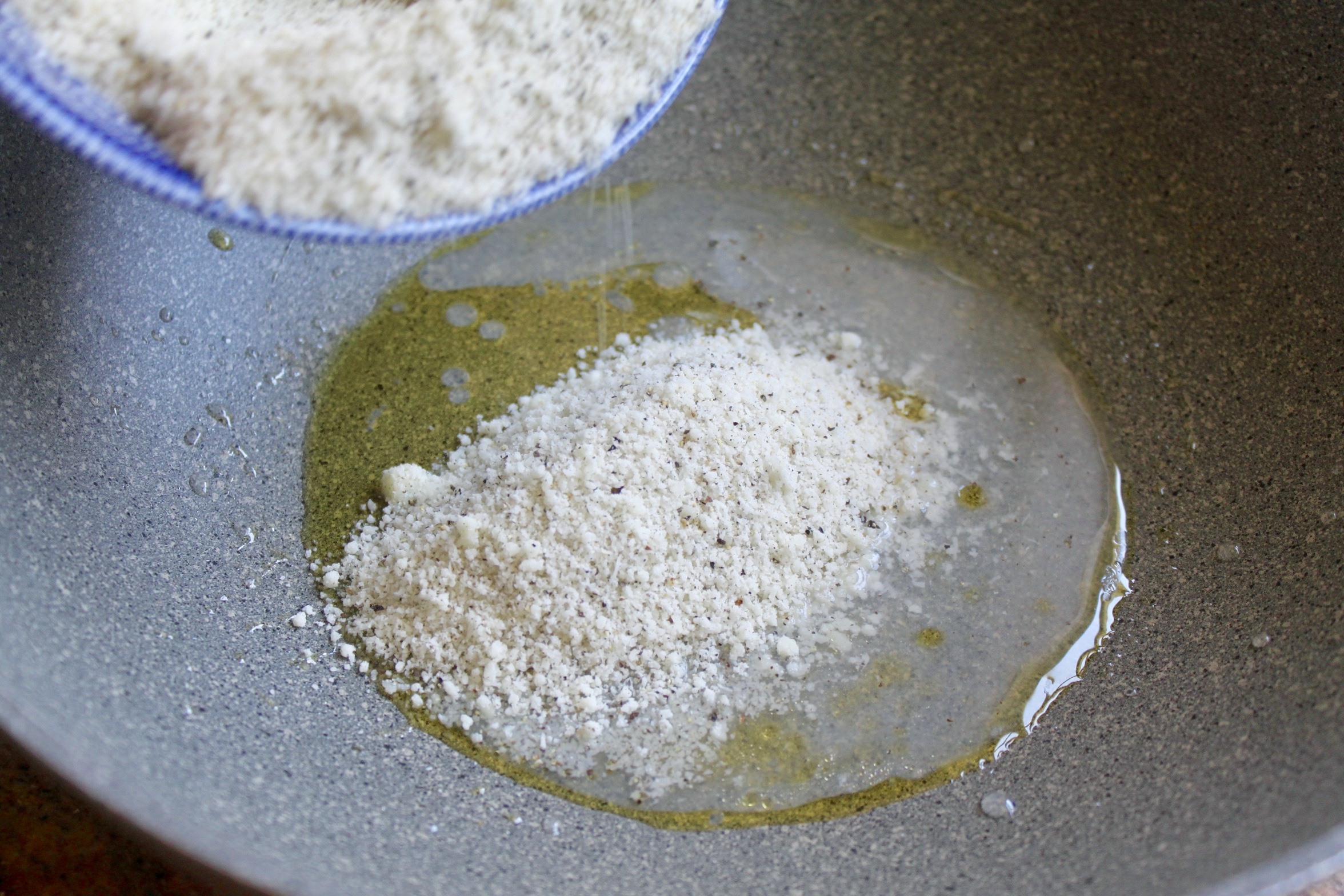 adding cacio e pepe to the pan