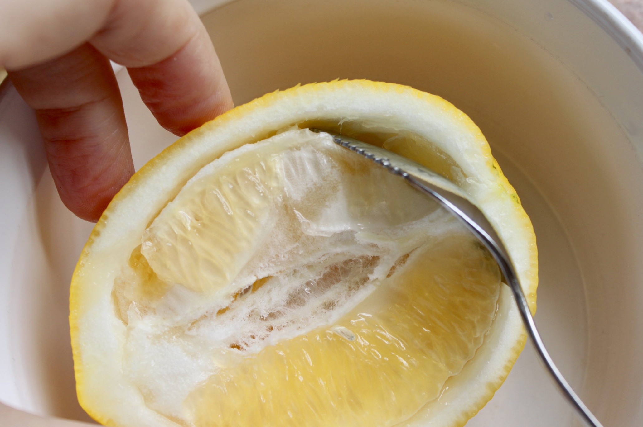 scooping out lemon for granita