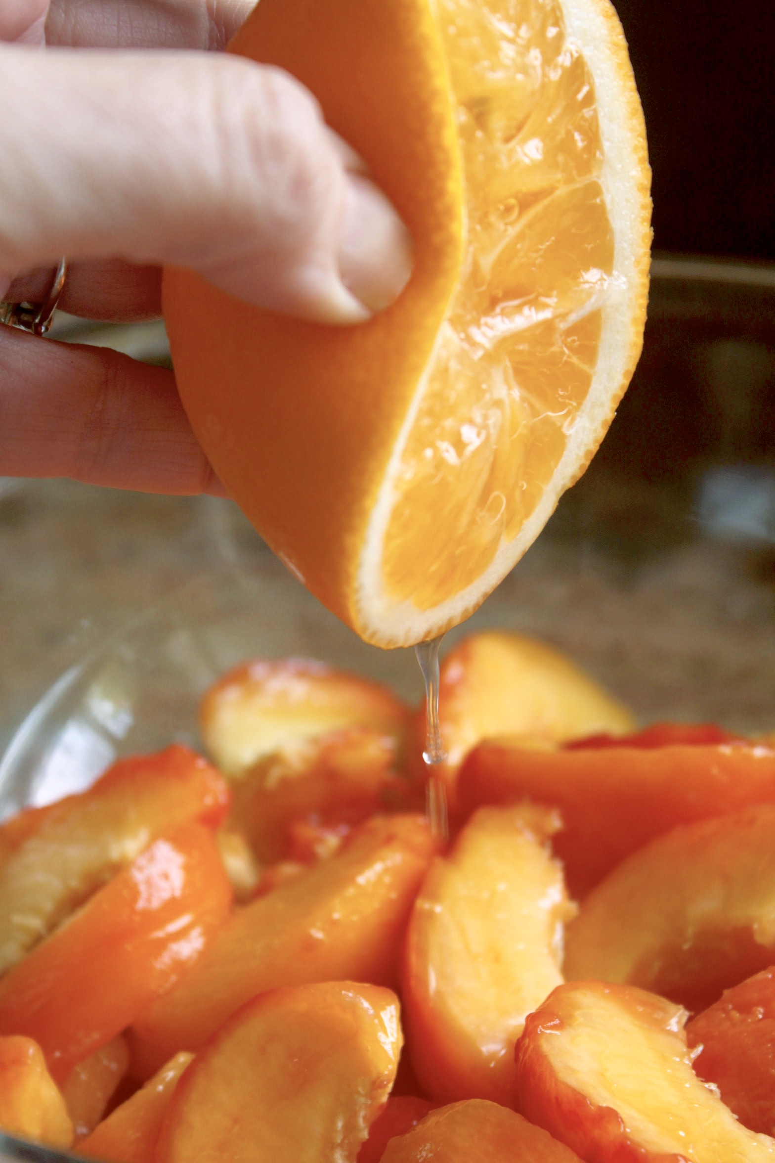 squeezing lemon into peaches