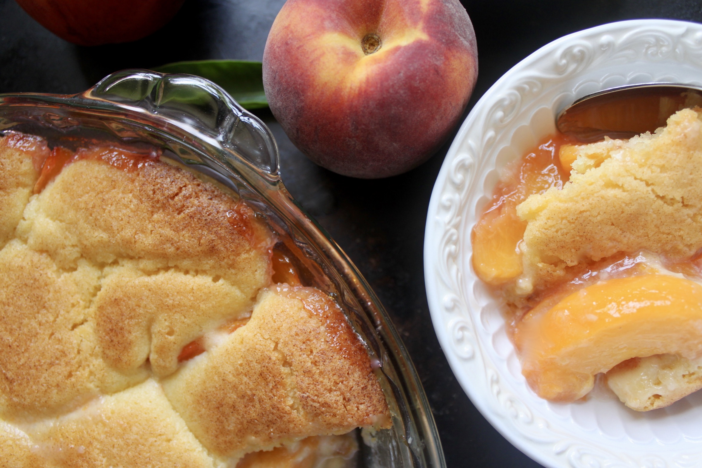 overhead peach cobbler in bowl with peach