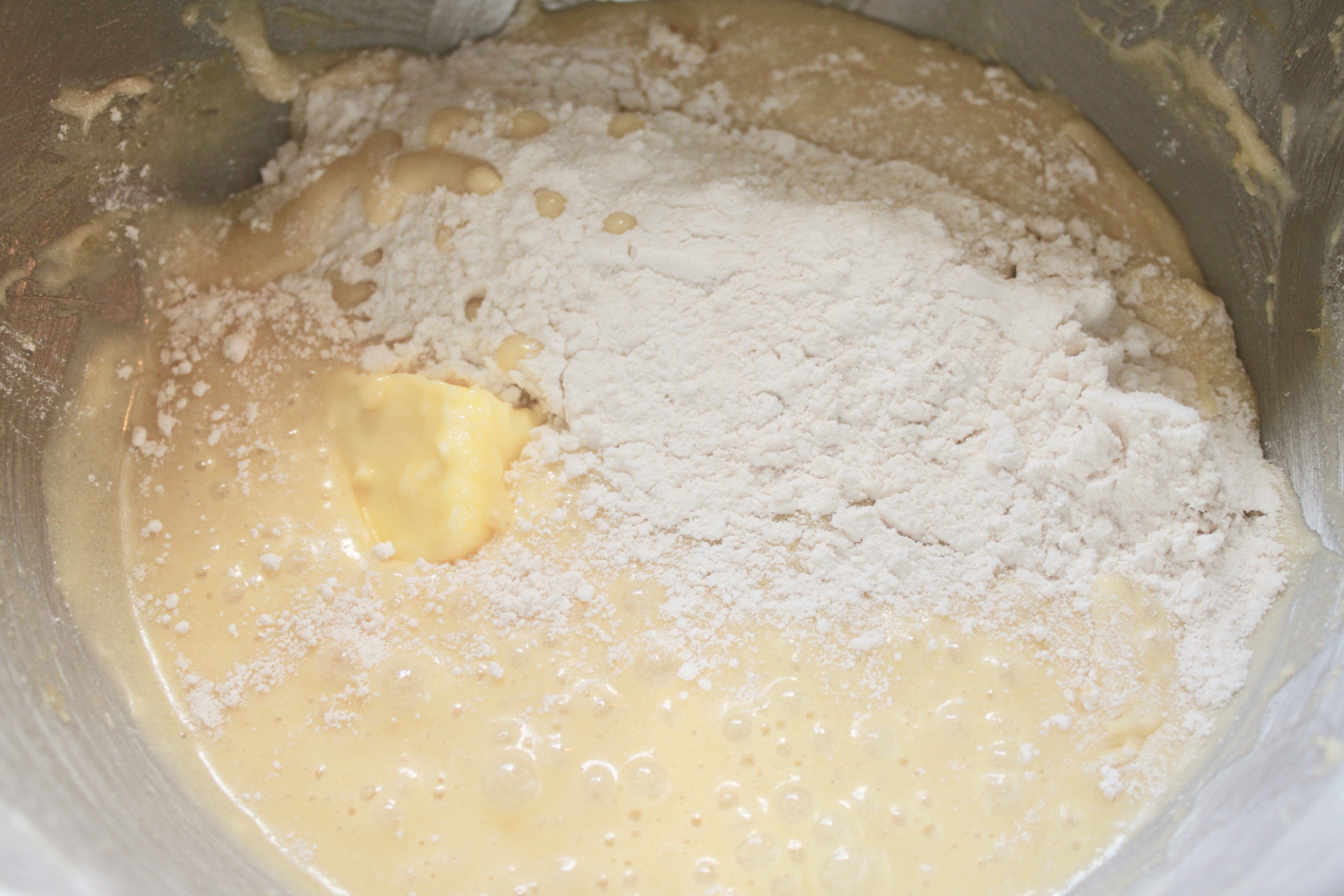 adding butter and flour to batter