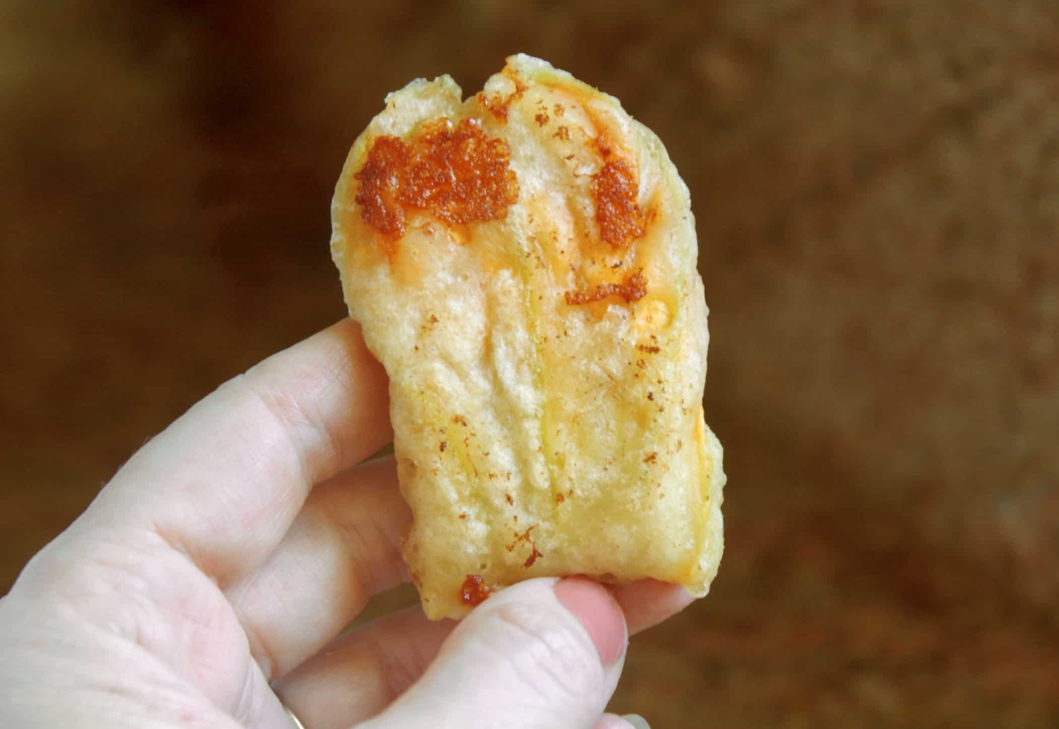 fried zucchini flower with cheese handheld