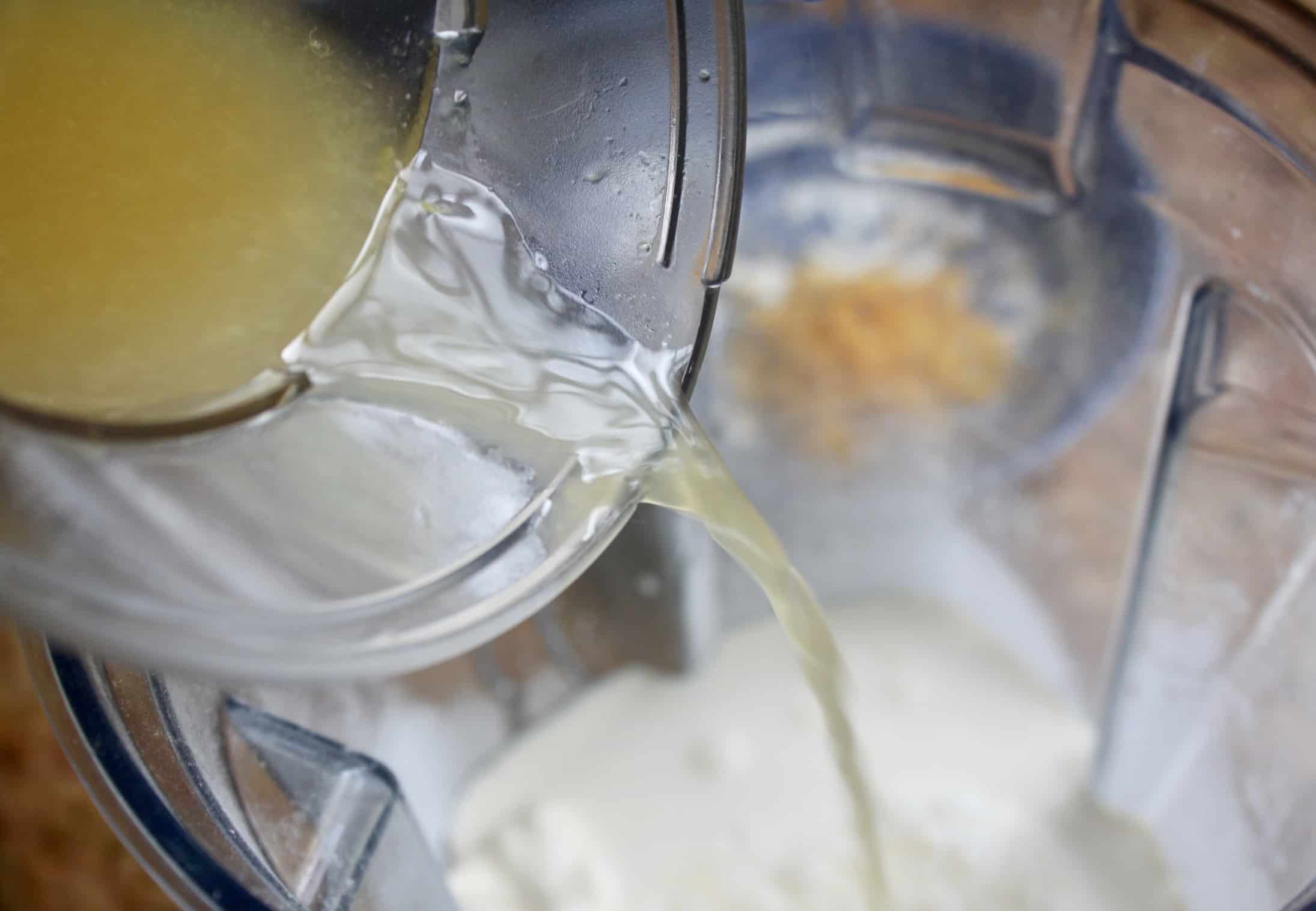 pouring lemon juice into blender