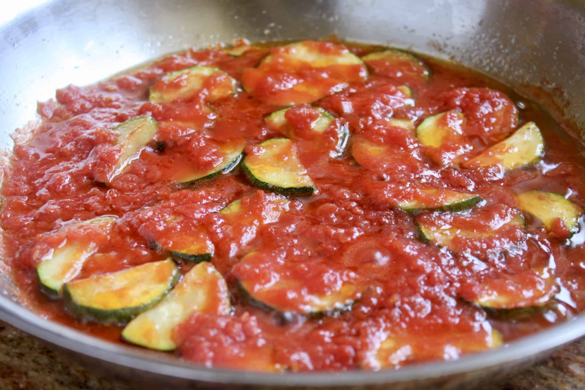 simmering tomatoes with zucchini