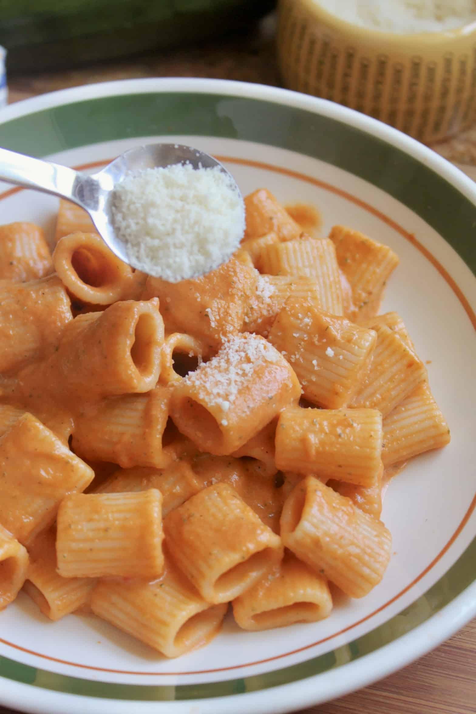 adding Parmesan cheese to pasta