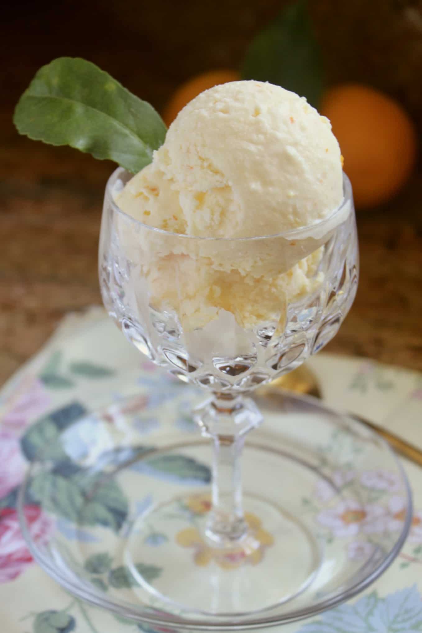 crystal glass with orange ice cream and an orange leaf decoration