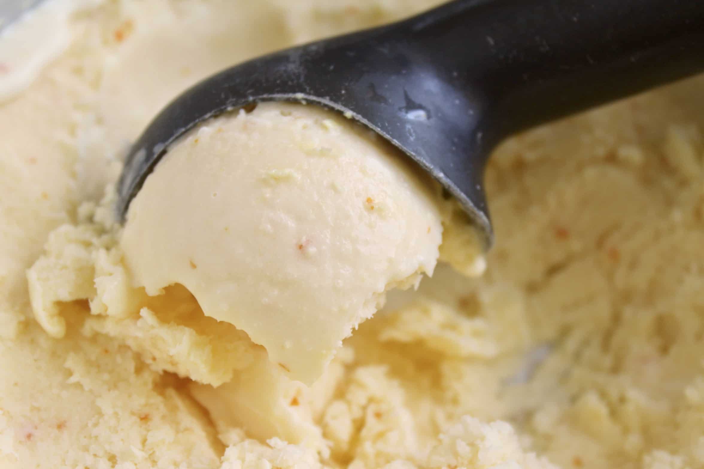 using an ice cream scoop to serve ice cream