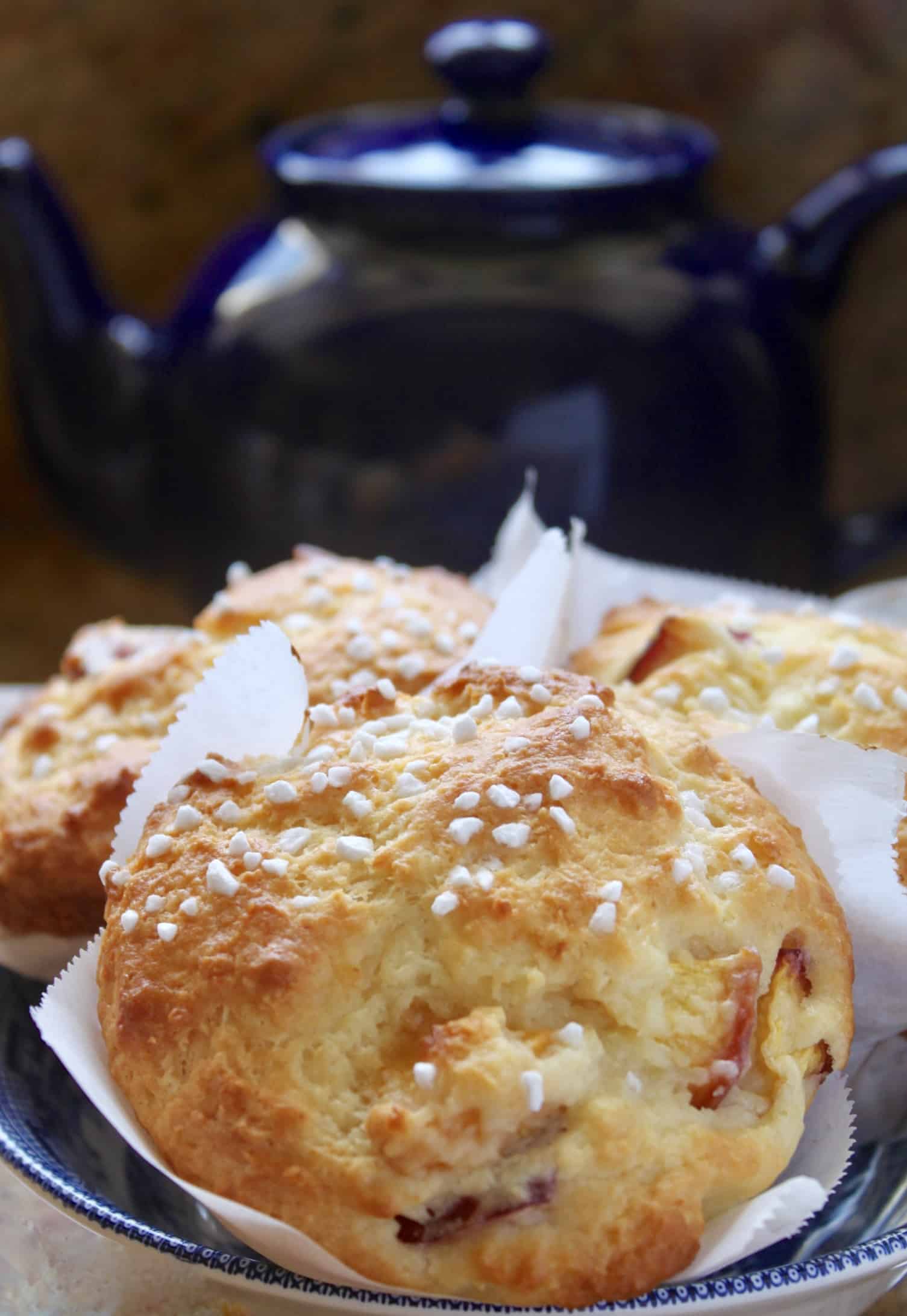 peach muffin with out of focus teapot in the background