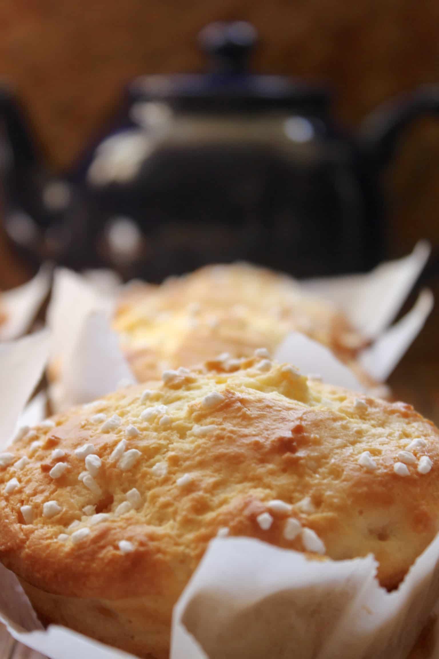 peach muffin with out of focus teapot in the background