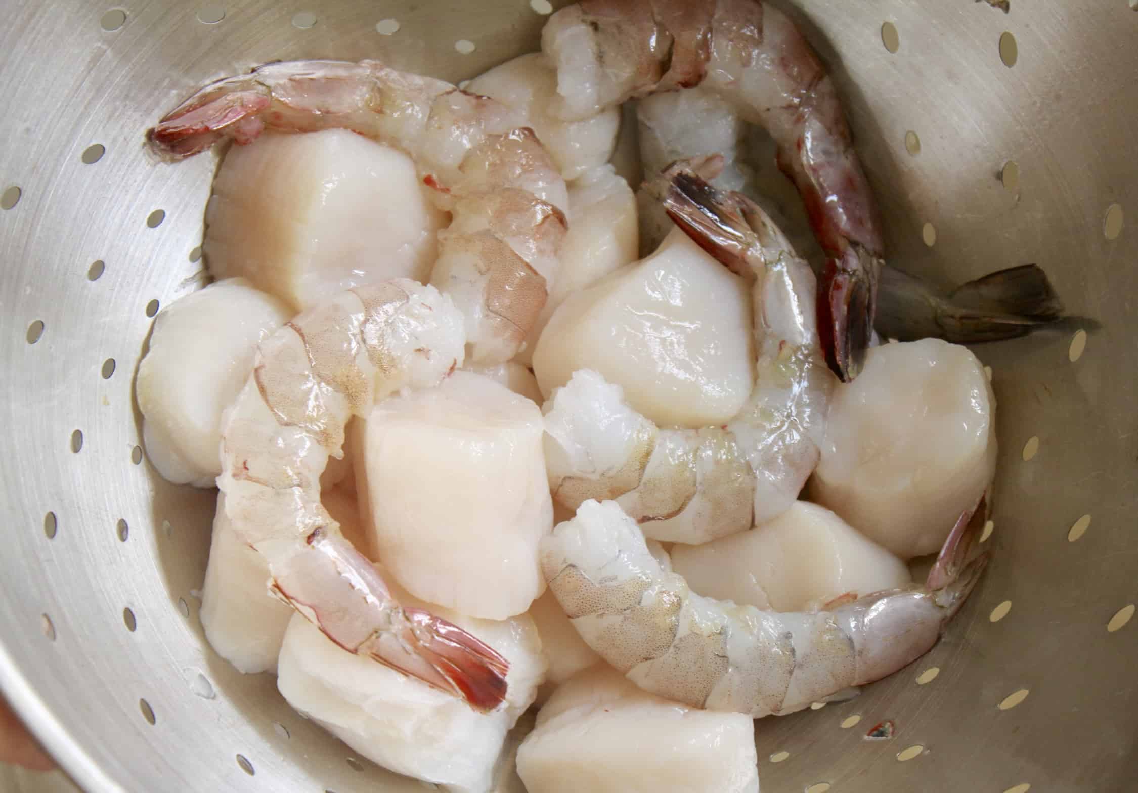 shrimp and scallops in colander