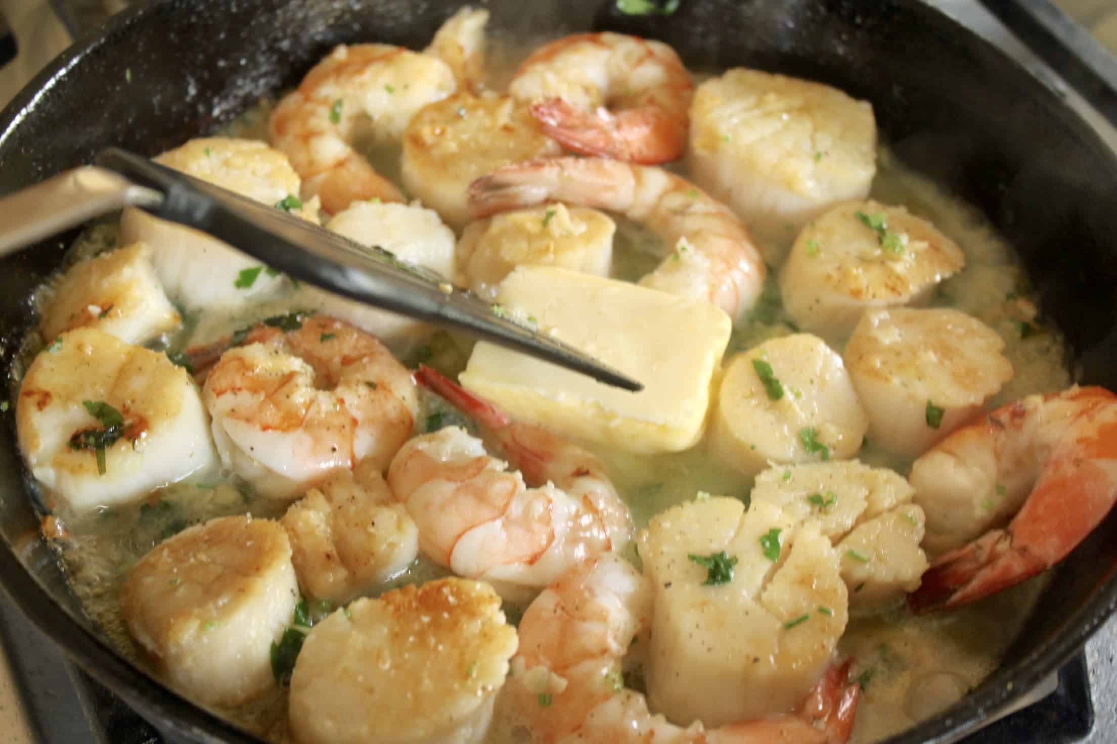 adding butter to seafood sauce