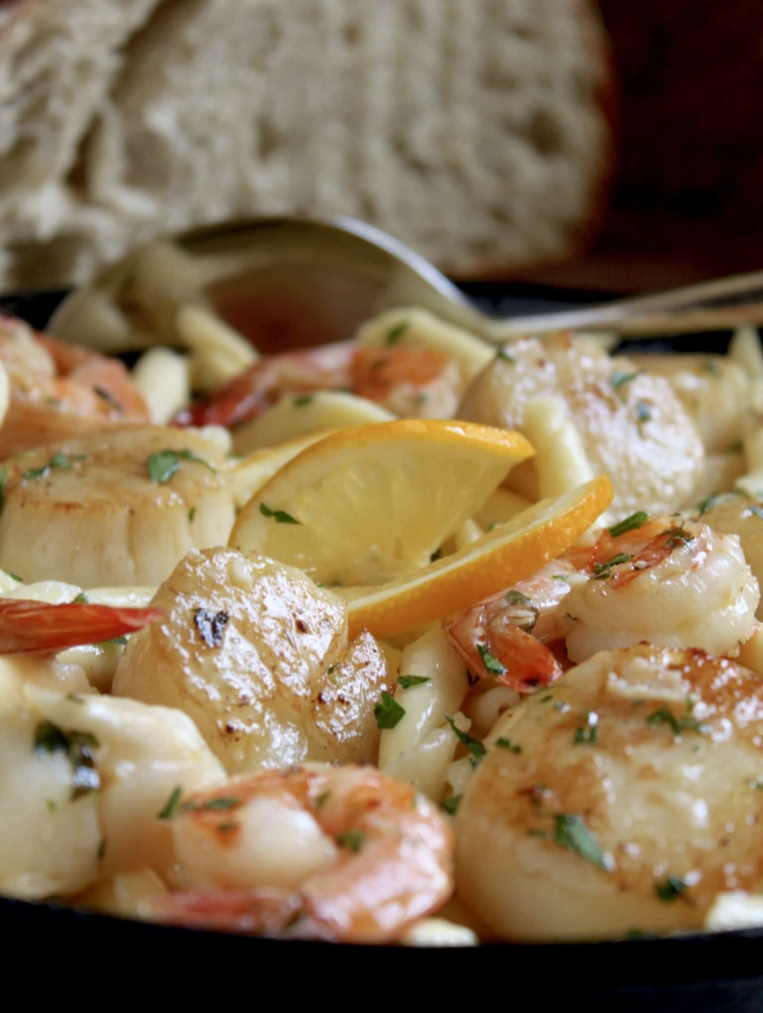 seafood pasta with shrimp and scallops in cast iron pan