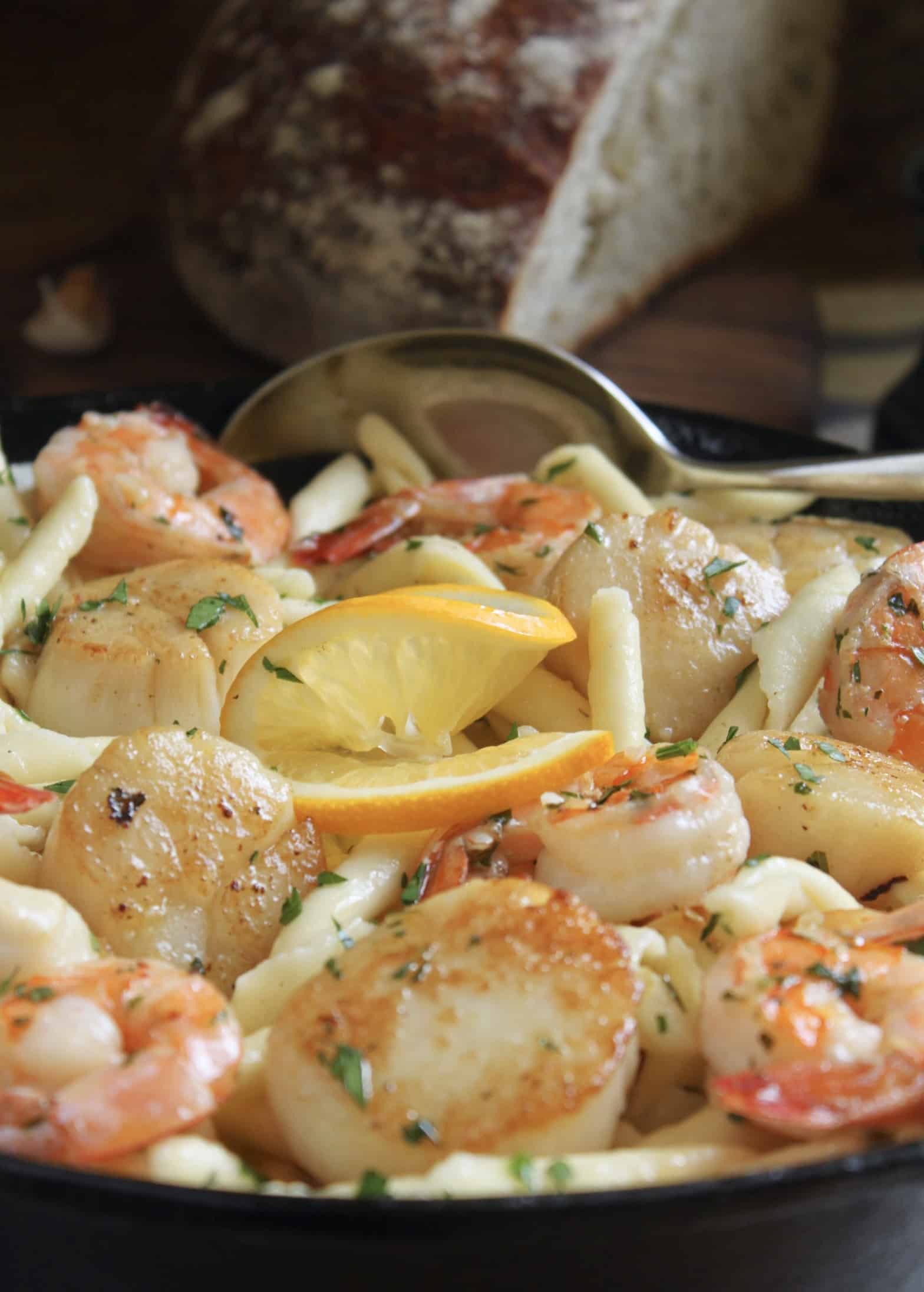 seafood pasta with shrimp and scallops in cast iron pan