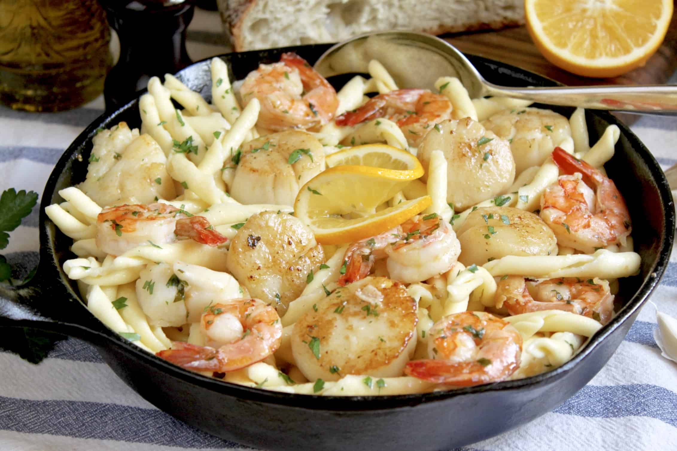 seafood pasta with shrimp and scallops in cast iron pan