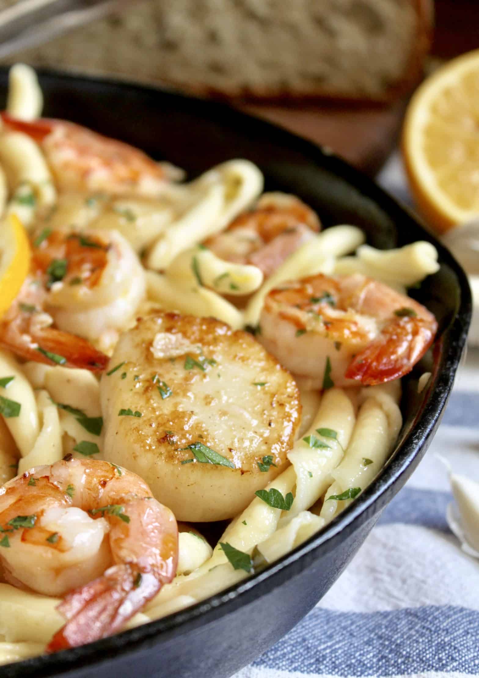 seafood pasta with shrimp and scallops in cast iron pan