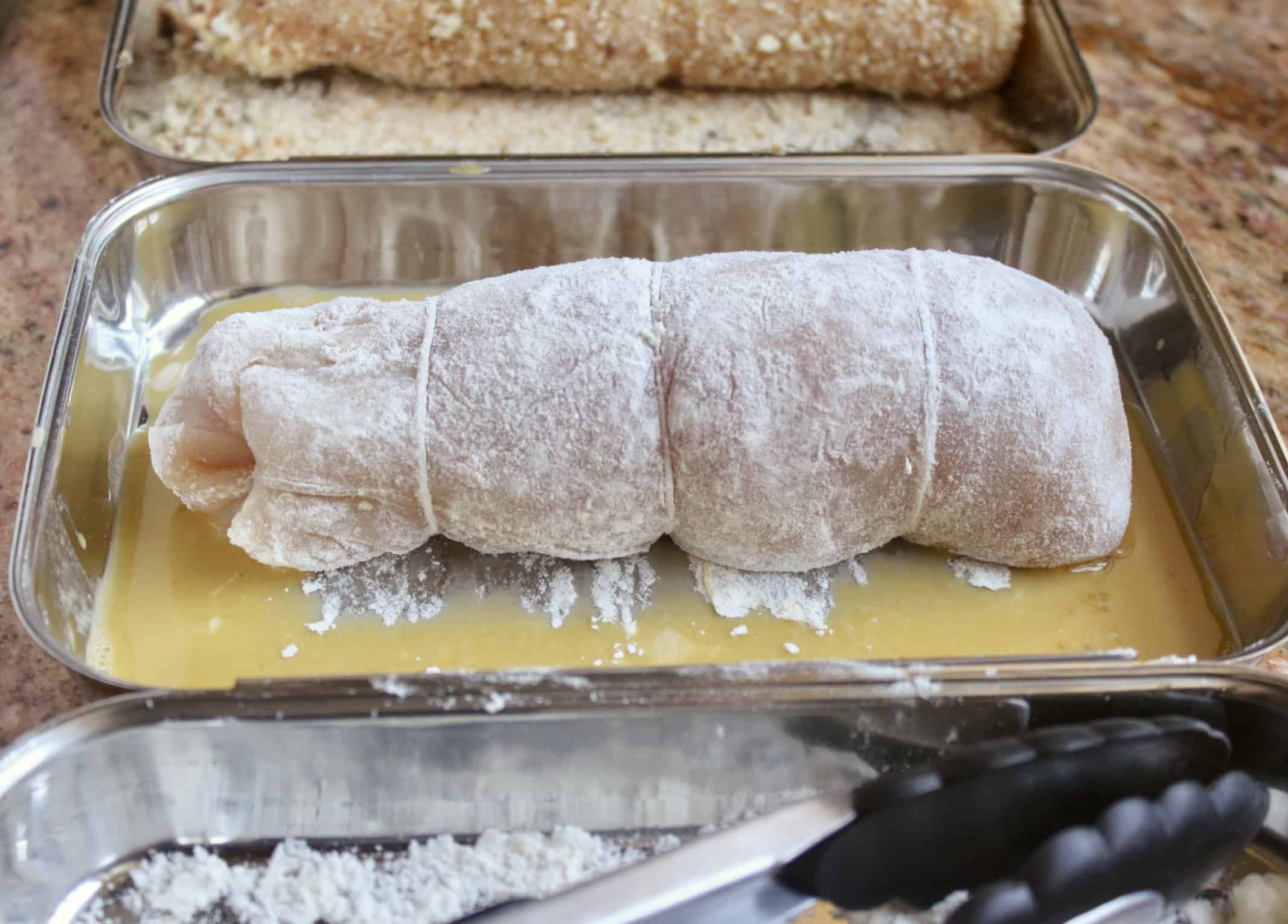 rolling chicken breast in egg and breadcrumbs