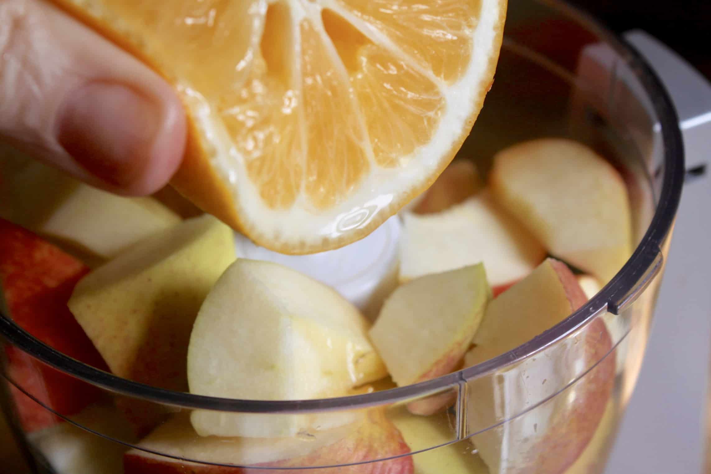 squeezing lemon juice onto apple