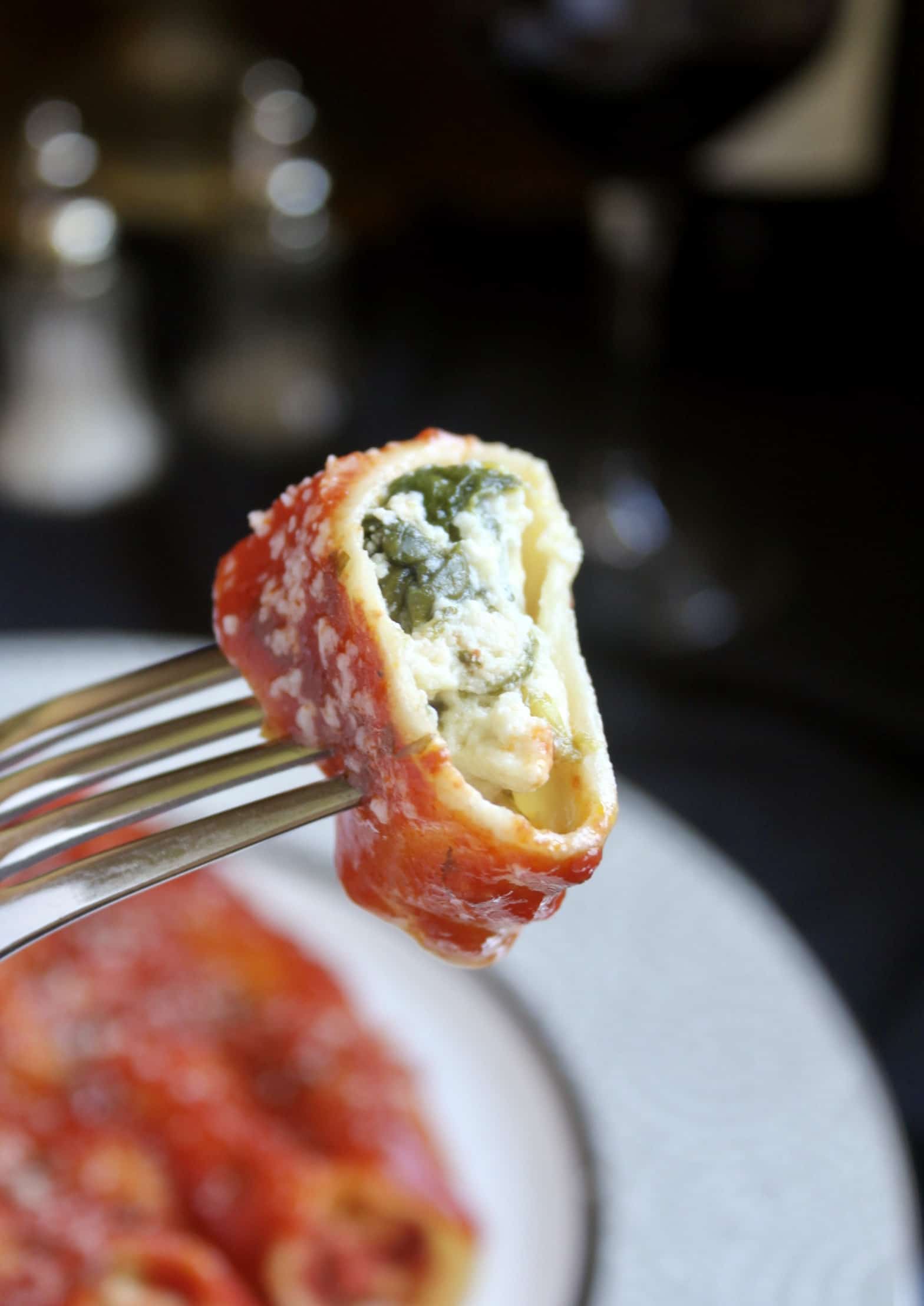 piece manicotti on a fork showing filling