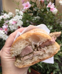 porchetta panino with flowers in the background