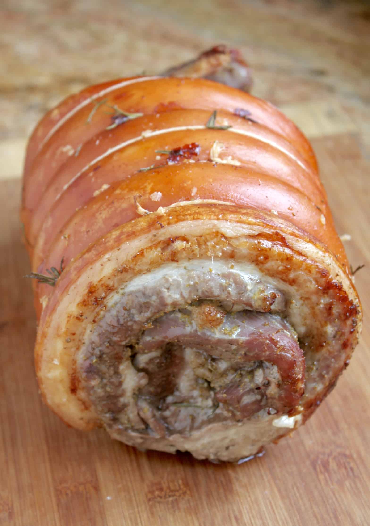 uncut porchetta on a board 