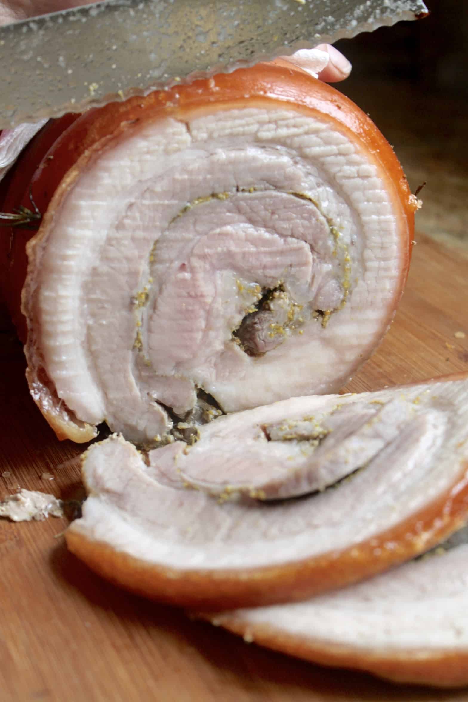 slicing porchetta roast